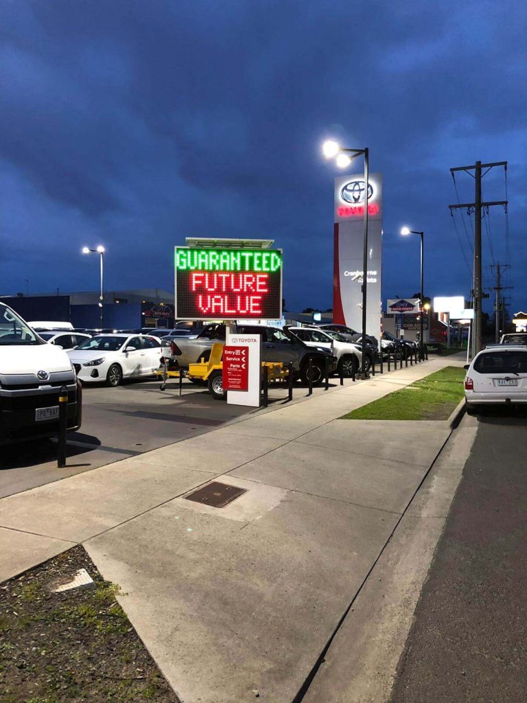 5-colour VMS trailer sign outside Brighton Toyota showroom on Nepean Hwy advertising ‘Guaranteed Future Value’