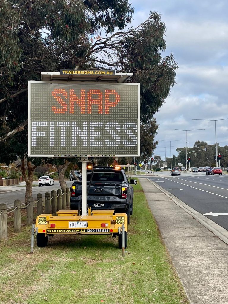 5-colour VMS trailer sign in Clyde Nth advertising ‘Snap Fitness memberships” in their signature brand colour text