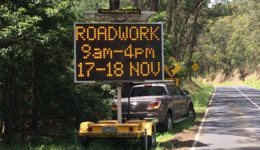 A warning sign indicating roadworks ahead on the highway, alerting drivers to potential delays and detours.