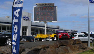 Exterior view of a Ford dealership with a visible sign